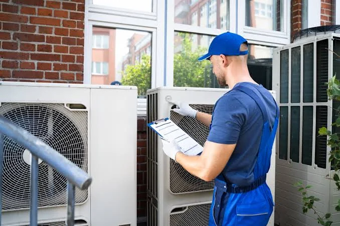 HVAC technician documenting an outdoor system maintenance inspection